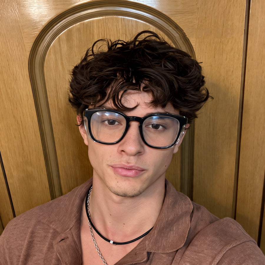 Man wearing Adapt Dew glasses indoors in front of a wooden door